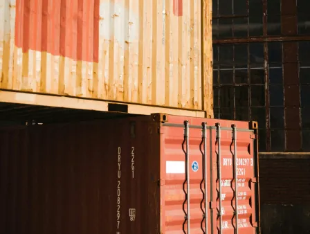 Stacked shipping containers in an industrial yard