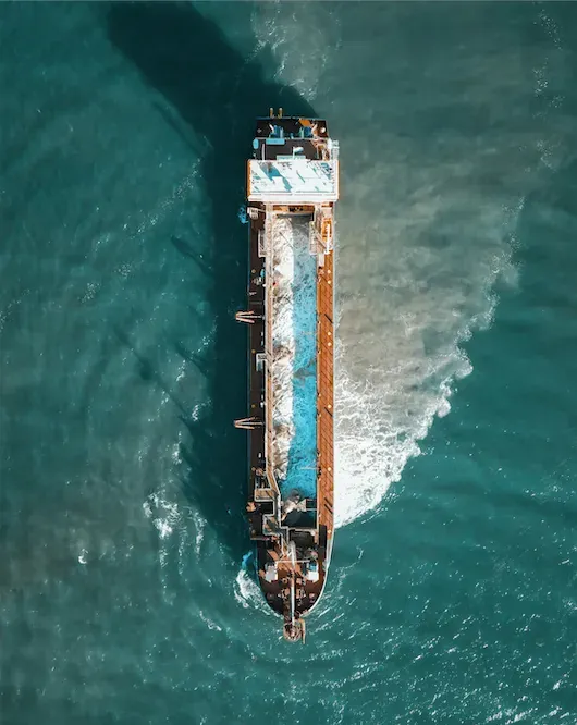 Aerial top-down view of a tanker underway in open water