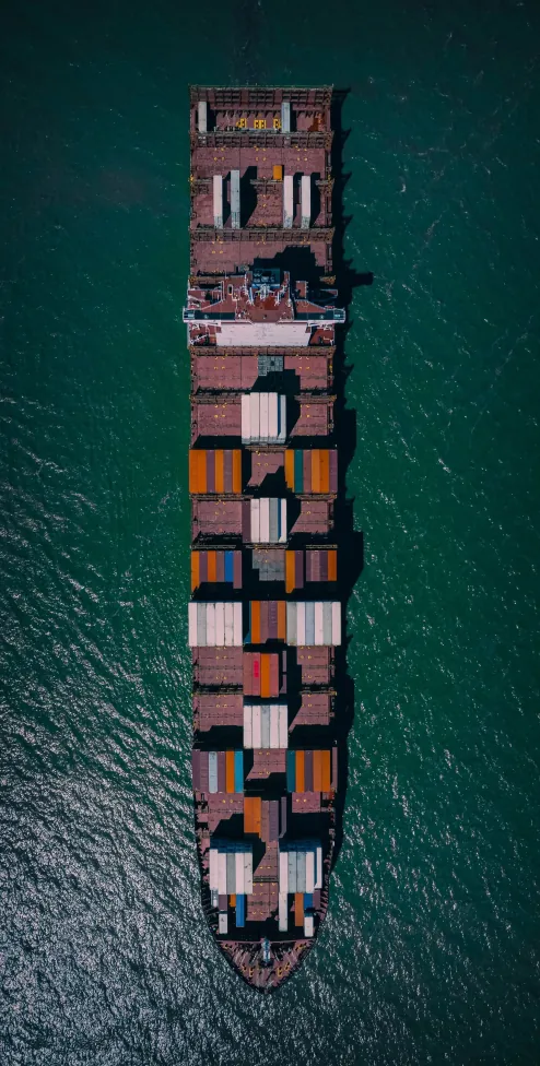 Aerial top-down view of a loaded container ship at sea