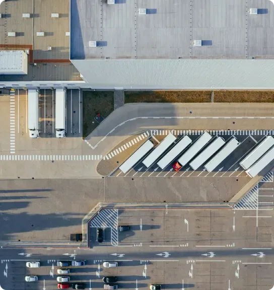 Aerial view of a logistics distribution center with trucks at its docks