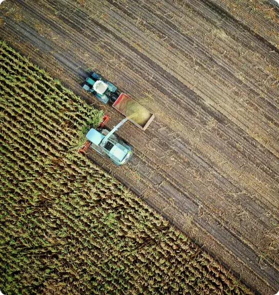 Aerial view of a harvester working an agricultural field
