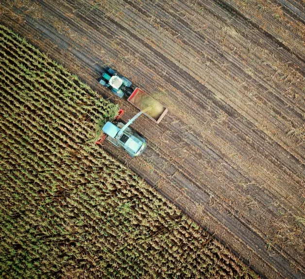 Aerial view of a harvester working an agricultural field