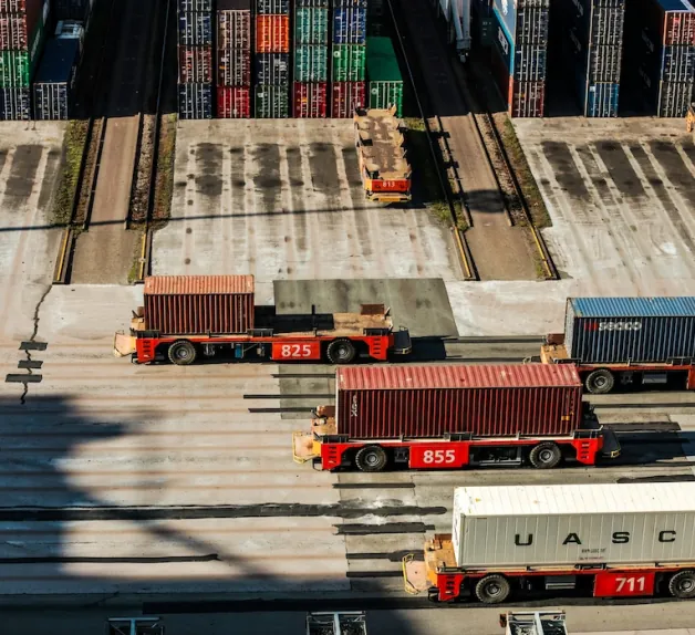 Aerial view of container carriers moving containers at a port terminal