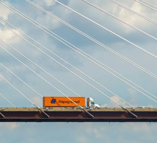 Container truck crossing a cable-stayed bridge