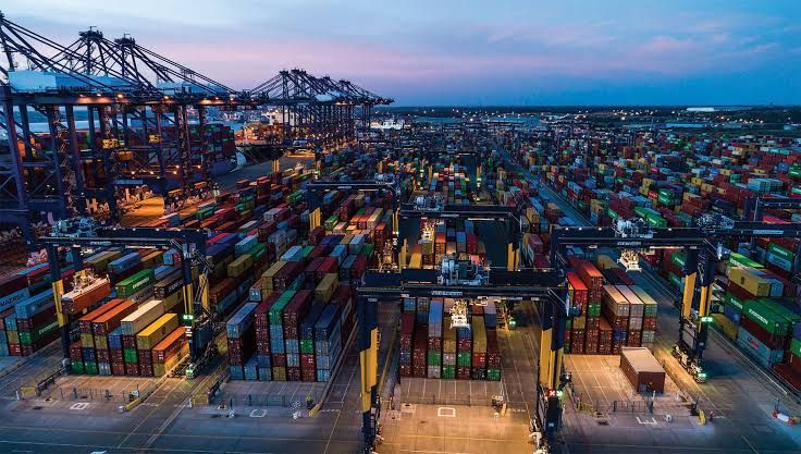 Container ship at UK port illustrating UK ETS surcharges on maritime shipping